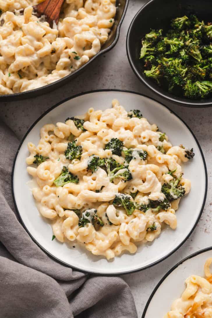 A plate of homemade mac and cheese stovetop with broccoli added.