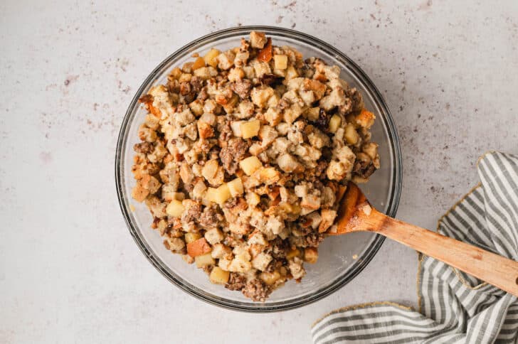 A bread stuffing mixture in a glass bowl.