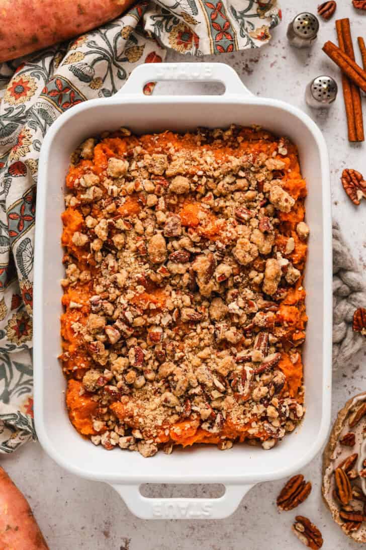 The best sweet potato casserole in a white baking dish.