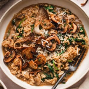 A mushroom risotto recipe in a shallow bowl.