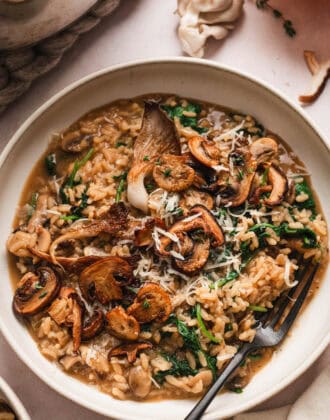 A mushroom risotto recipe in a shallow bowl.