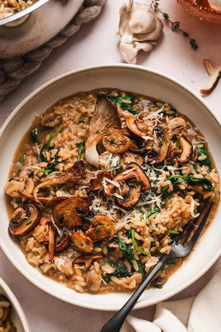 A mushroom risotto recipe in a shallow bowl.