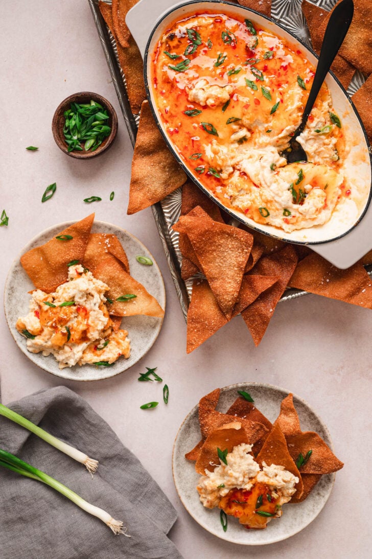 An overhead scene showing hot crab rangoon dip being served with wonton chips.