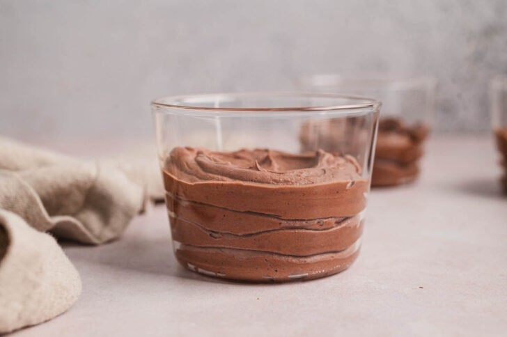 A small glass bowl filled with a chocolate mousse recipe (no eggs).