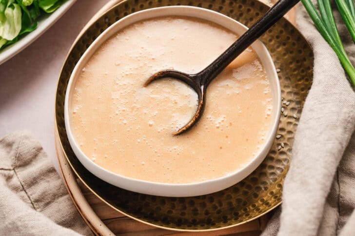 A miso dressing recipe in a white bowl.