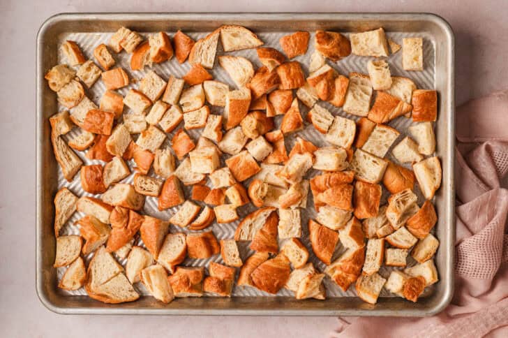 Cubed pastries on a baking pan.