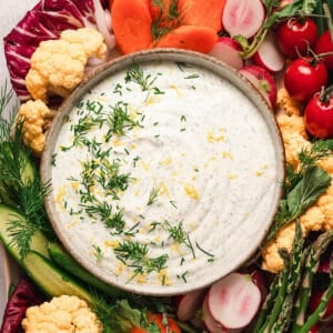 A tray of dill veggie dip and fresh cut vegetables.