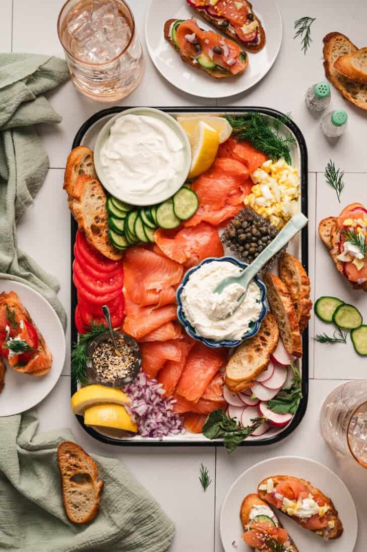 A smoked salmon platter on a white surface.