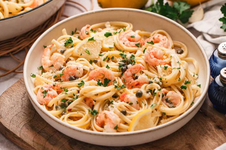 A low bowl filled with lemon butter shrimp pasta.