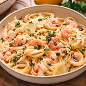 A low bowl filled with lemon butter shrimp pasta.