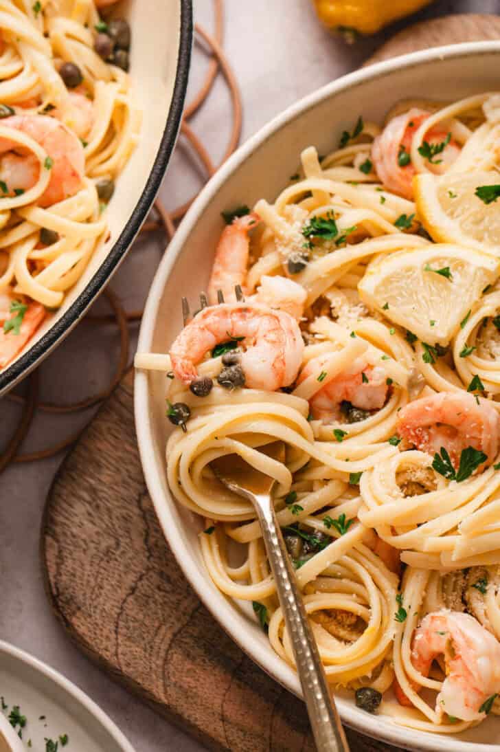 A fork twirling lemon caper linguine with shrimp