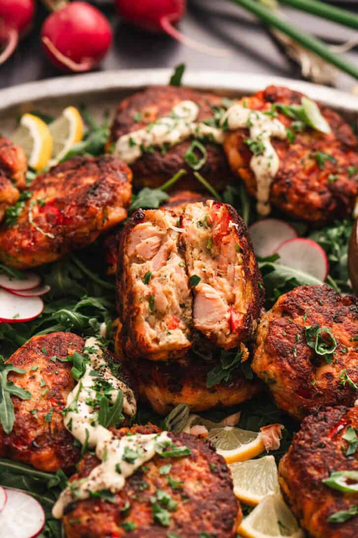 A salmon cake broken in half so you can see the flaked fish on the inside.