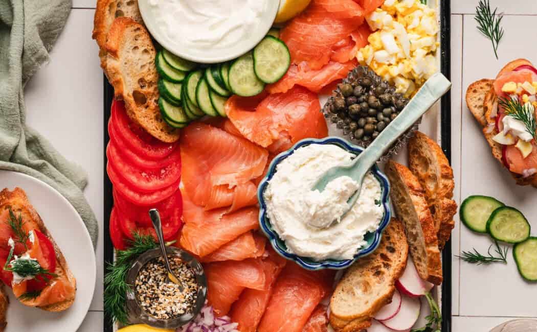 A smoked salmon platter on a white surface.