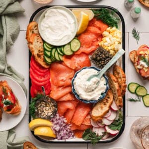 A smoked salmon platter on a white surface.