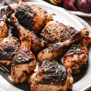 Grilled buttermilk marinated chicken on a white platter.