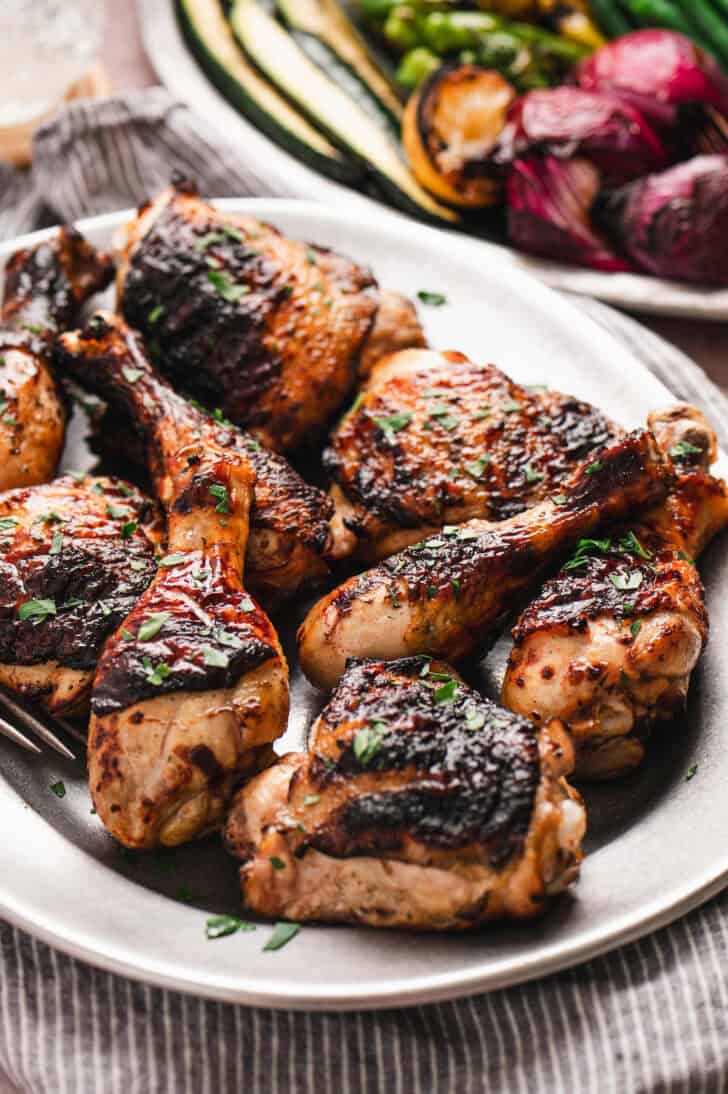 Grilled buttermilk marinated chicken on a white platter.