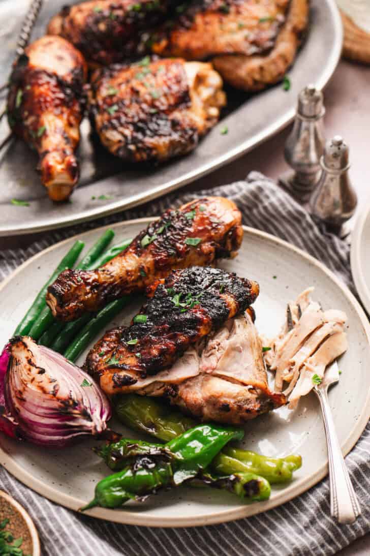 Buttermilk grilled chicken on a platte with grilled vegetables.