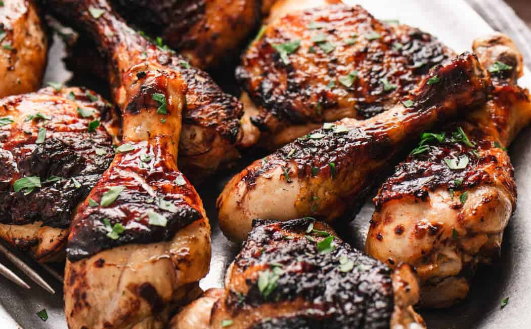 Grilled buttermilk marinated chicken on a white platter.