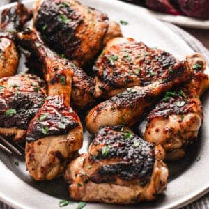 Grilled buttermilk marinated chicken on a white platter.