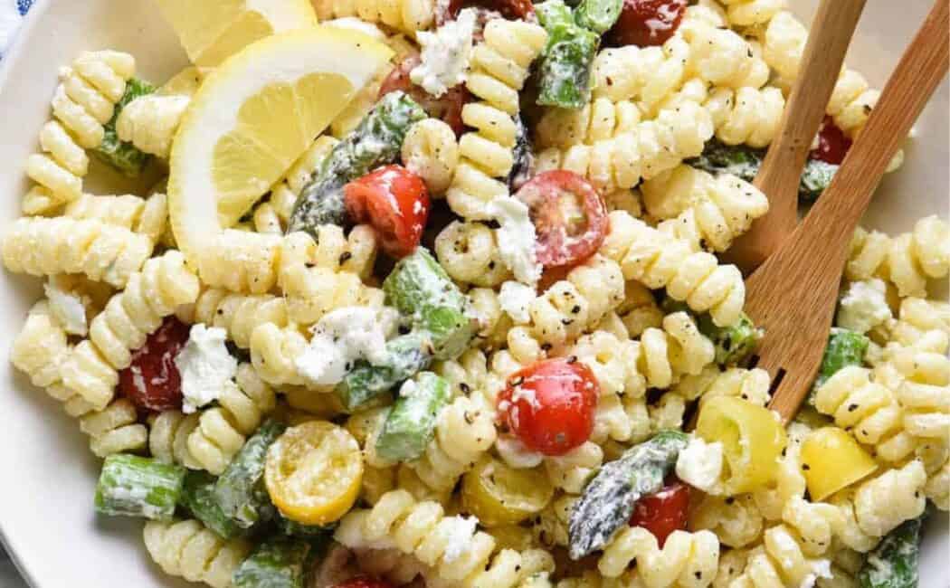 Goat cheese pasta salad in a white bowl.
