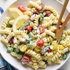 Goat cheese pasta salad in a white bowl.