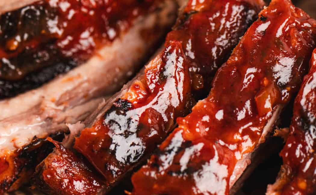 Sliced root beer ribs on brown paper.