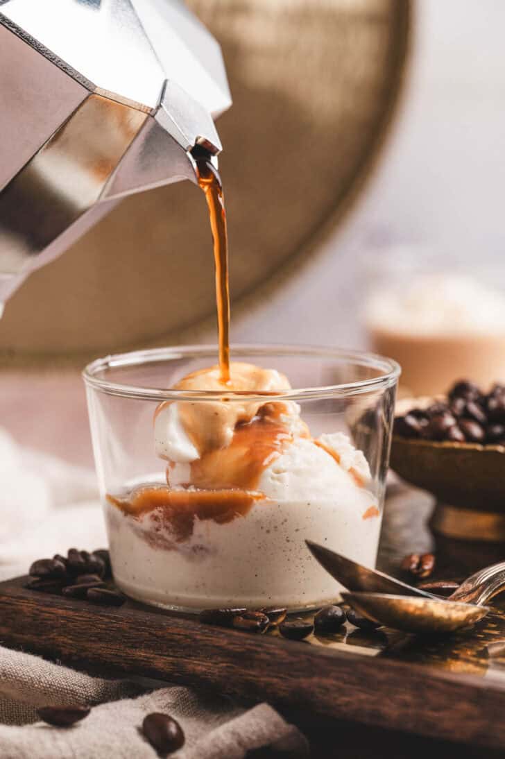 Coffee being poured over a dish of ice cream to make an affogato recipe.