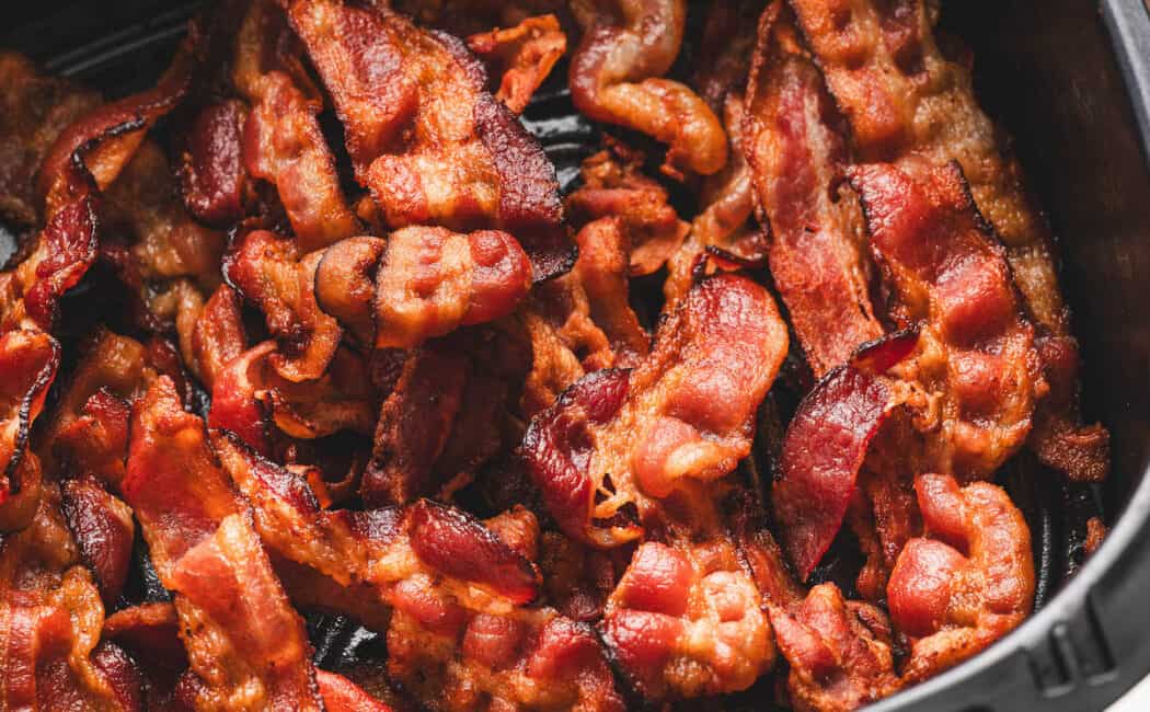 Bacon in air fryer basket.