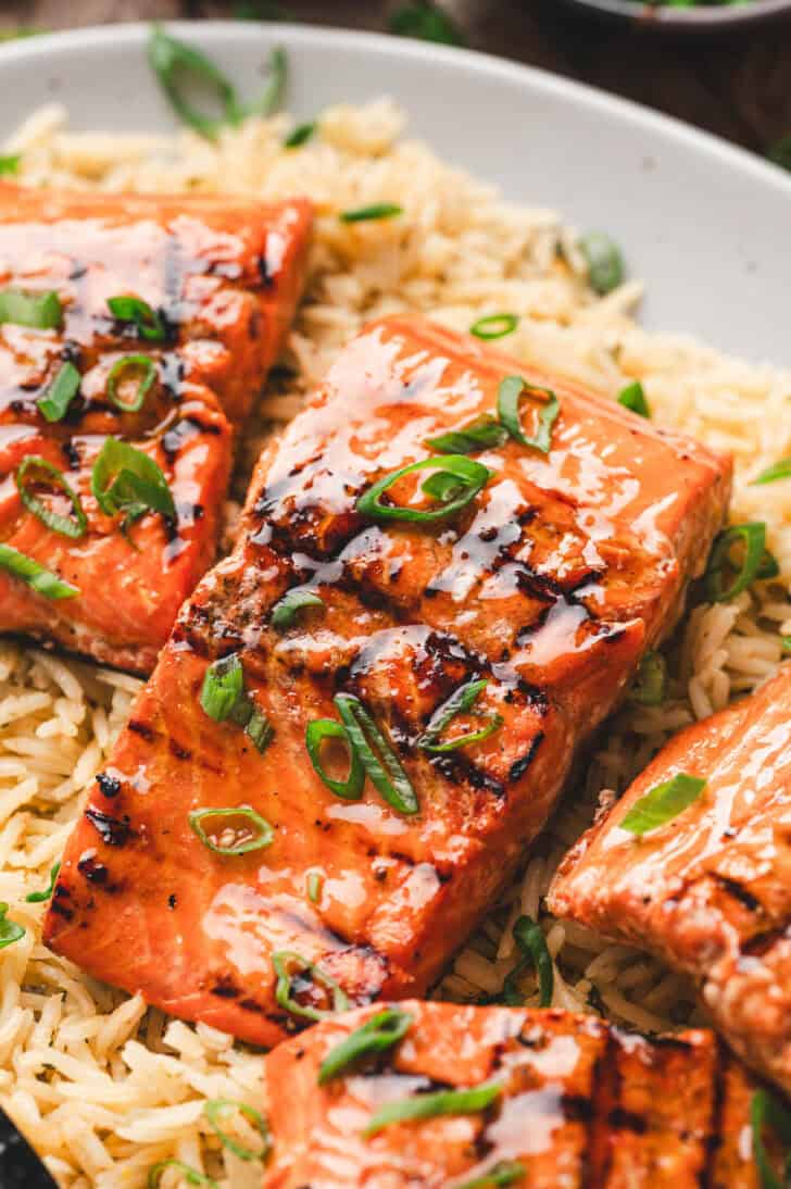 Cooked pink fish over rice.