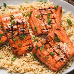 A platter filled with the best grilled salmon recipe over rice.