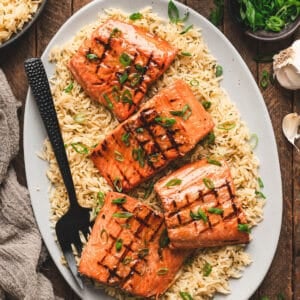 A platter filled with the best grilled salmon recipe over rice.