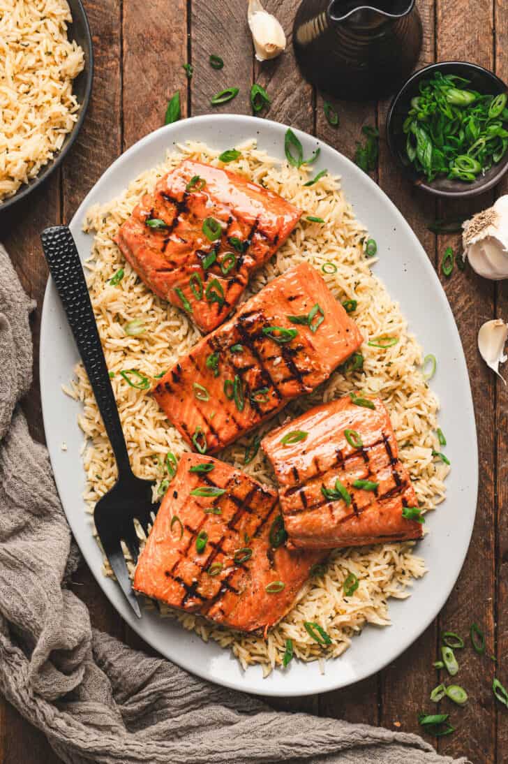 A platter filled with the best grilled salmon recipe over rice.