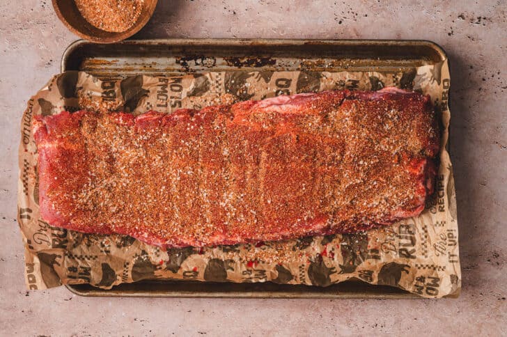 A slab of pork meat rubbed with spices.