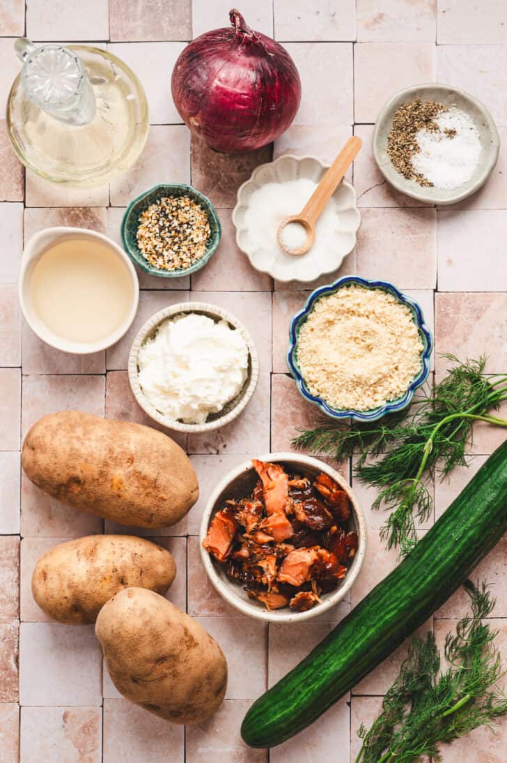 Two photos showing ingredients on a light surface, including root vegetables, cucumbers, onion, smoked salmon, herbs, breadcrumbs, oil and spices.