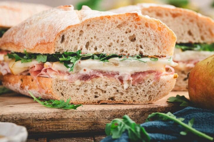 A prosciutto sandwich recipe, cut in half to show the colorful layers.