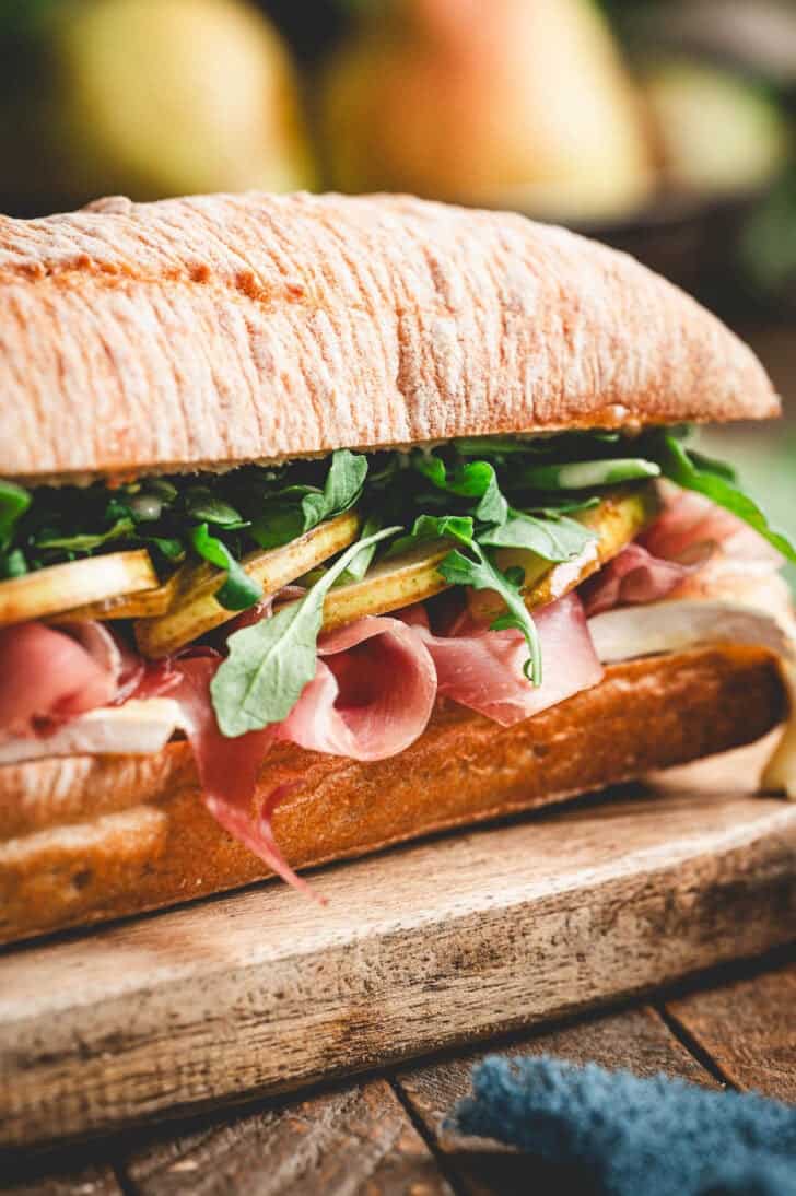 The best prosciutto sandwich on a wooden cutting board.