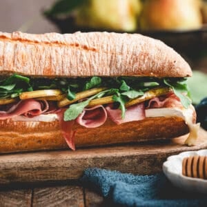 The best prosciutto sandwich on a wooden cutting board.
