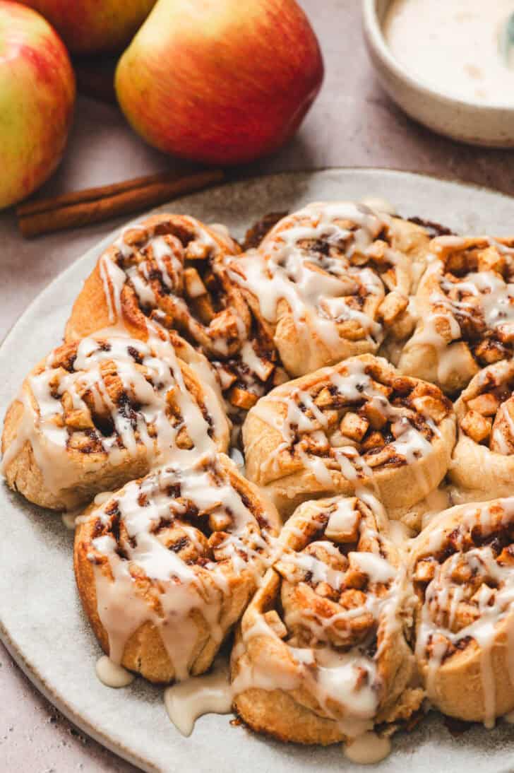 Baked apple cinnamon rolls drizzled with glaze.