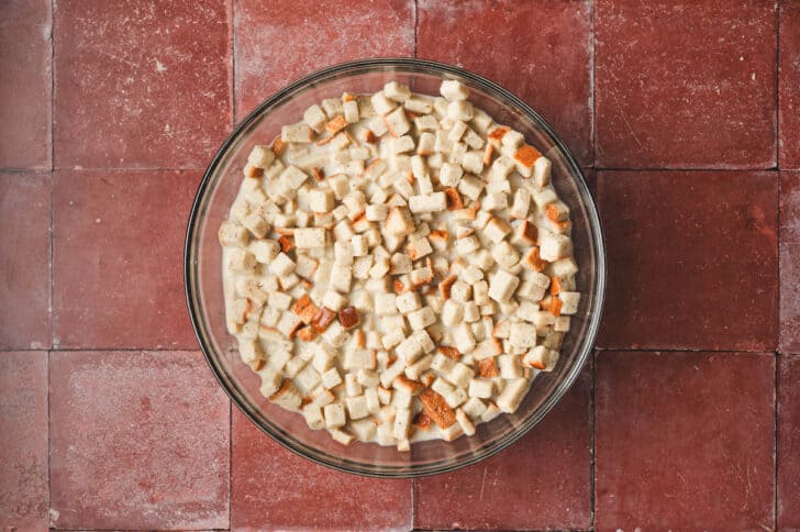 Cubes of bread in a glass bowl.