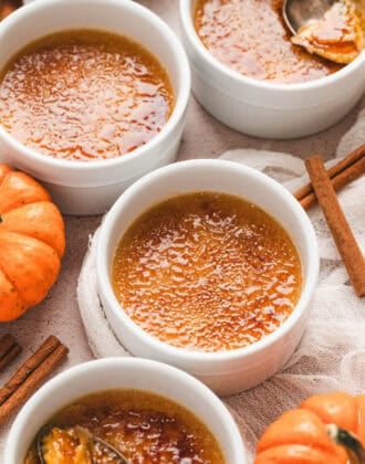Four ramekins of pumpkin creme brulee.