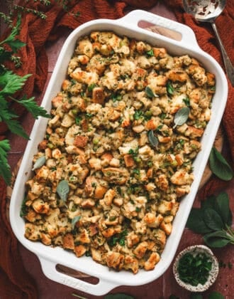 A white baking dish filled with a Thanksgiving stuffing recipe.