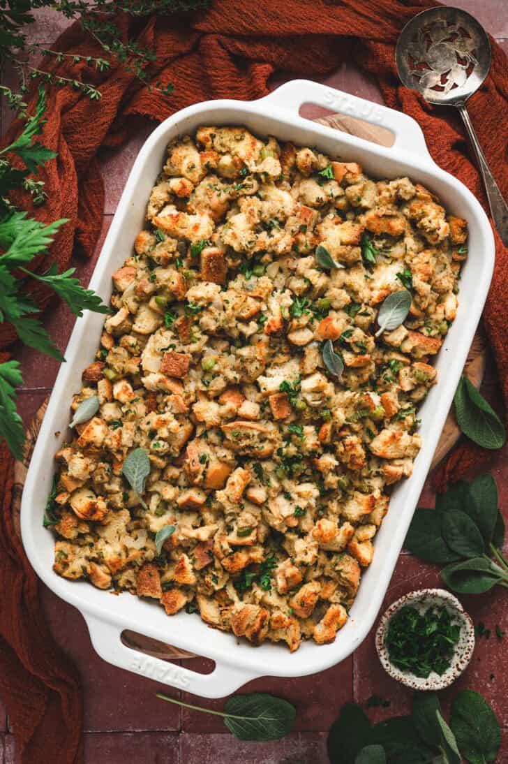 A white baking dish filled with a Thanksgiving stuffing recipe.