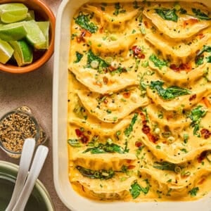 A white baking dish filled with a one pot dumpling recipe.