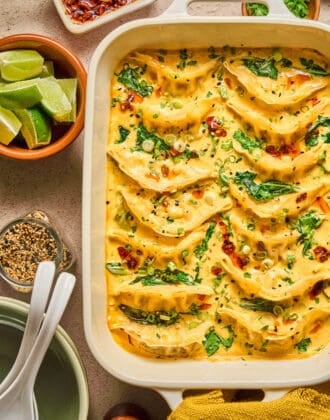 A white baking dish filled with a one pot dumpling recipe.