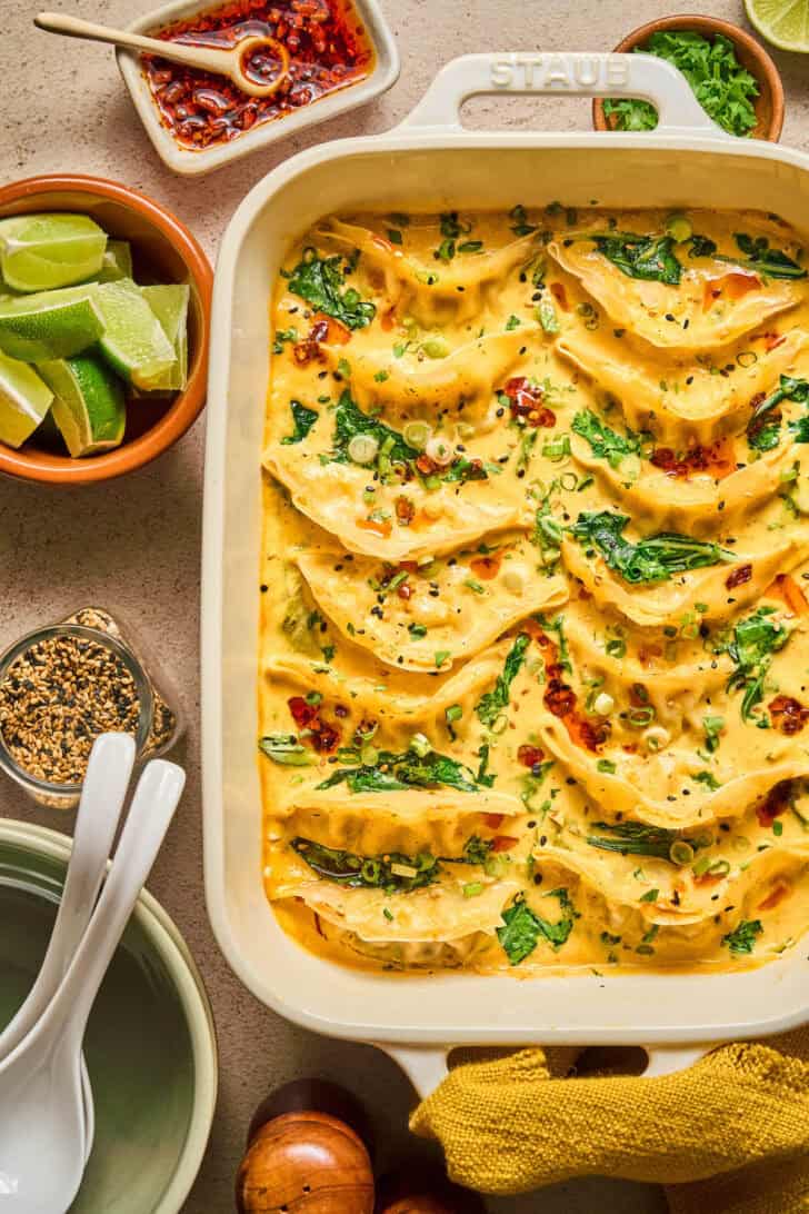A white baking dish filled with a one pot dumpling recipe.