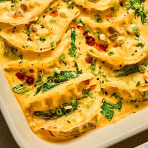A white baking dish filled with curry dumplings.