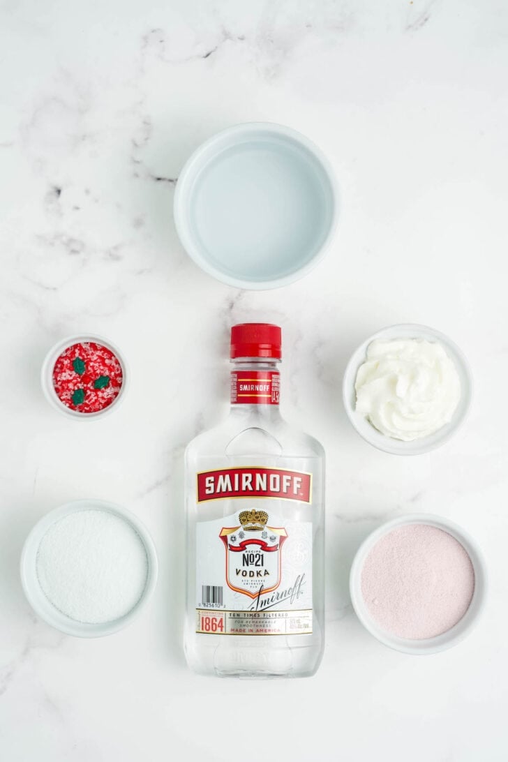 Vodka, sprinkles, whipped cream and powdered gelatin on a light background.