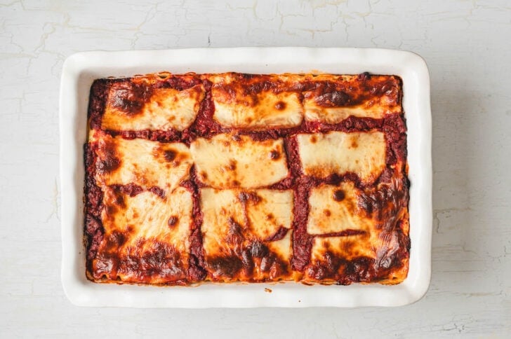 A cottage cheese lasagna recipe in a white baking dish after baking.