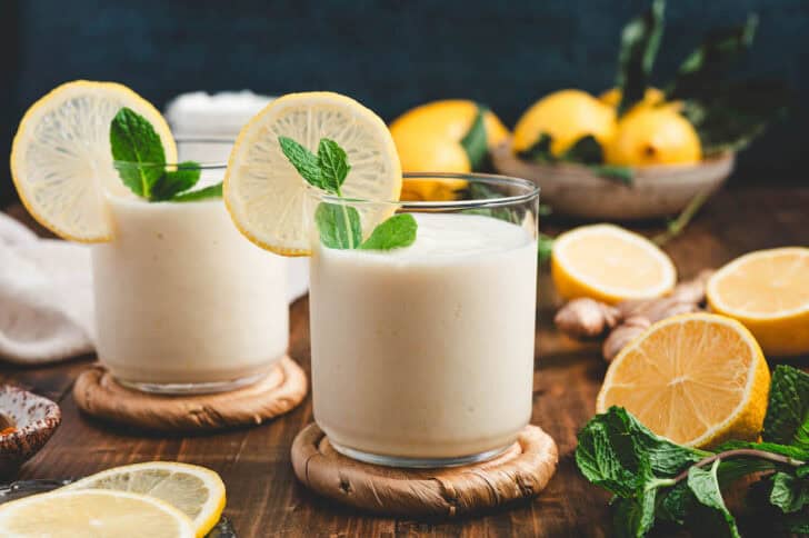 Light slushy beverages garnished with a fresh citrus wheel and mint.