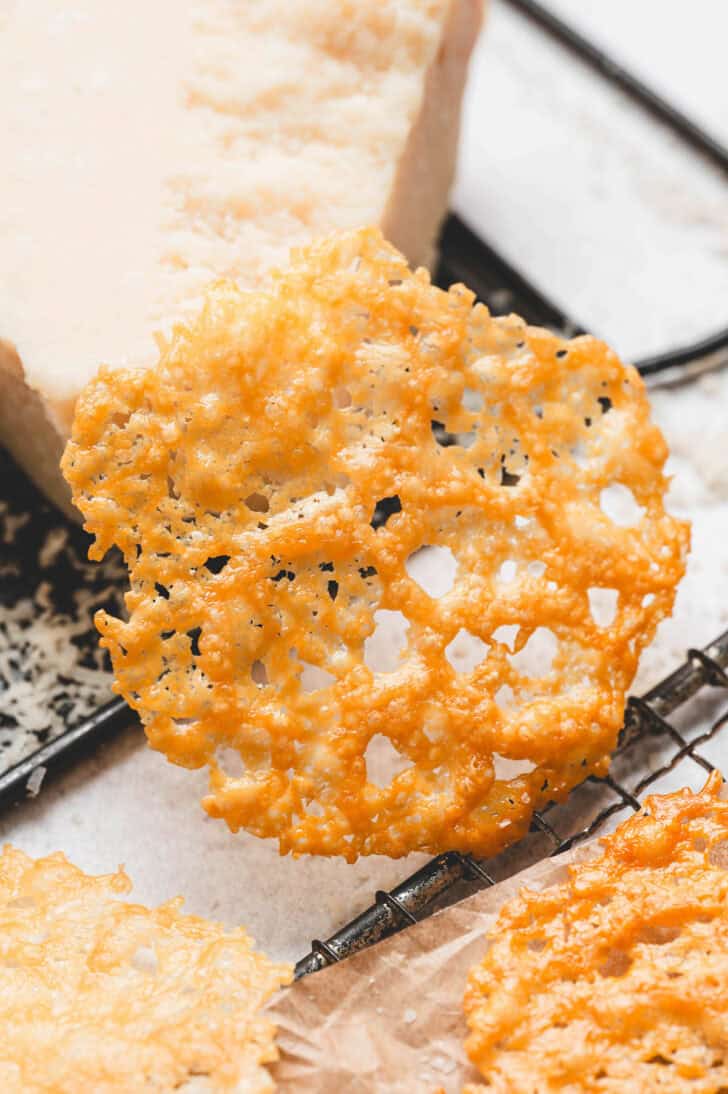 A Parmesan cheese crisp on a light background.